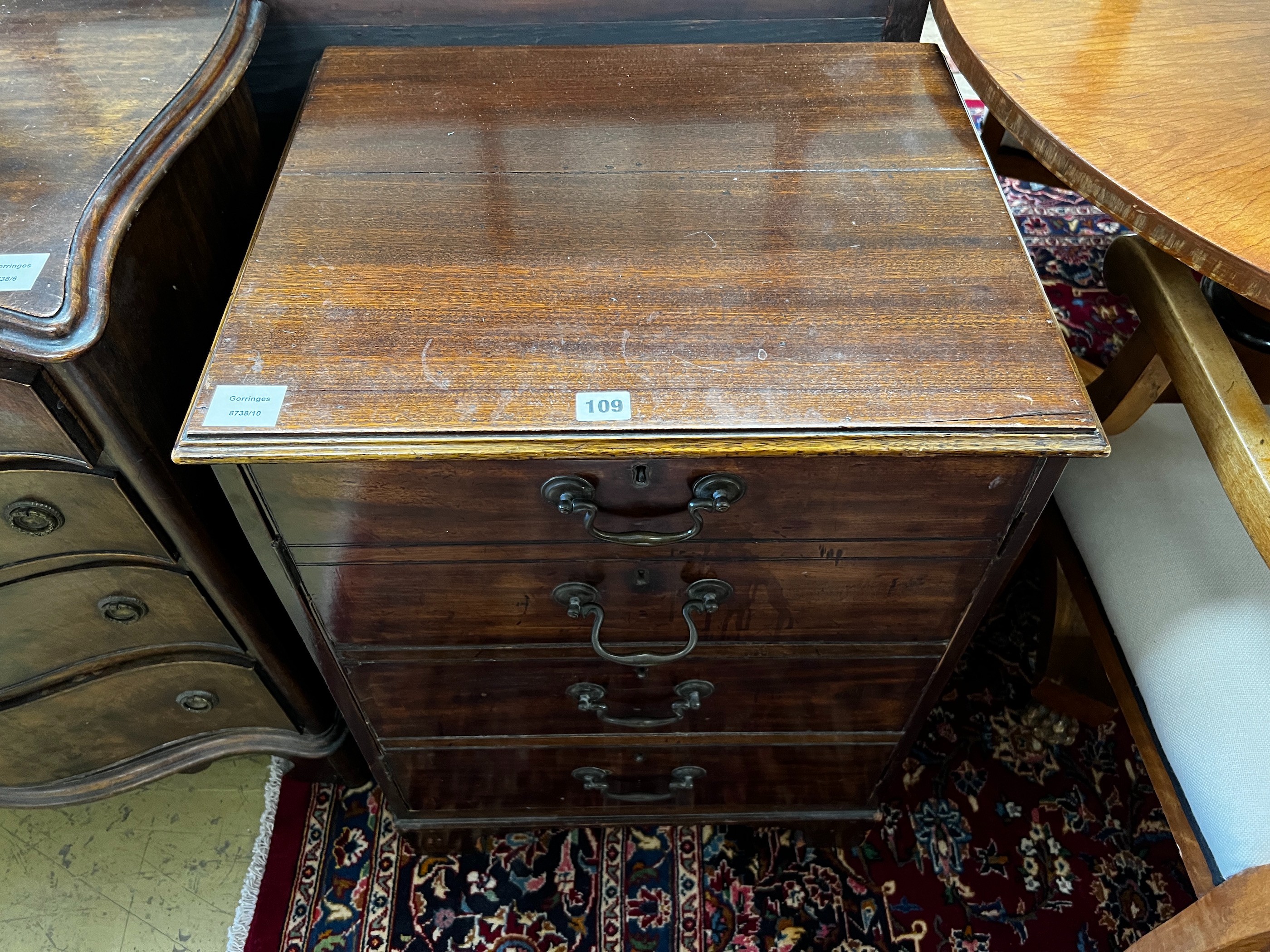 A George III and later mahogany side cabinet with dummy drawer front, incorporates old timber, width 53cm, depth 43cm, height 72cm, and a George III mahogany toilet mirror